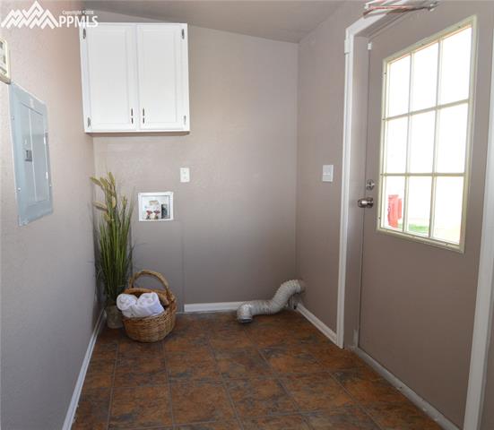 27055 Handle Road Calhan, CO 80808 - Photo 21 of 25 The laundry room, mud room and back door to the home.
