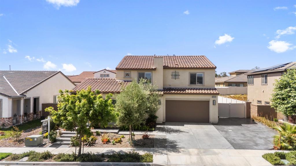 29809 Gypsy Vanner Way Menifee, CA 92584 - Photo 2 of 45 a front view of a house with a yard and garage