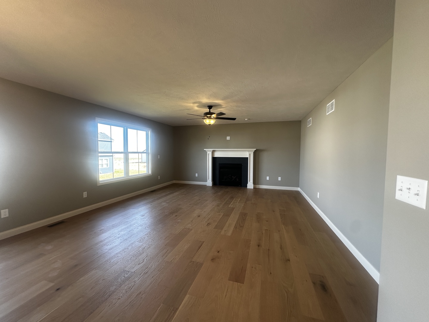 2 Roscoe Court Bloomington, IL 61705 - Photo 5 of 16 a view of empty room with wooden floor and fan