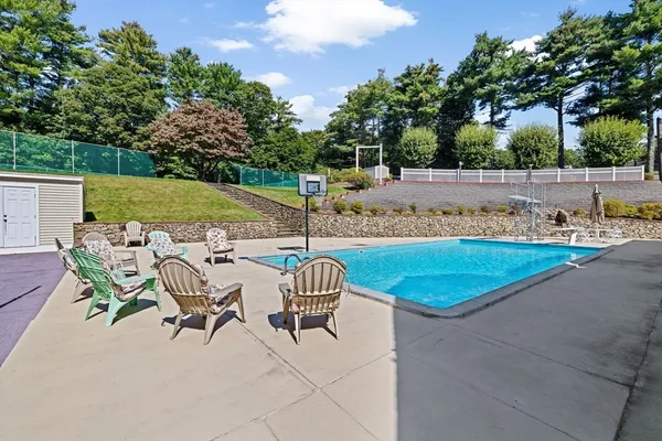 a view of a house with swimming pool and sitting area