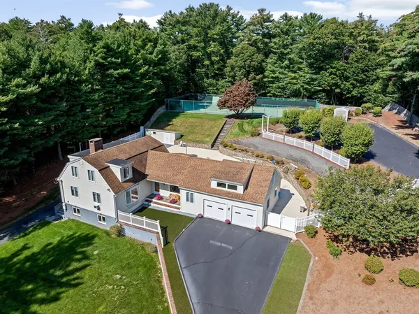 an aerial view of a house with garden space and trees