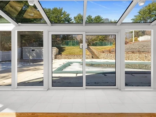 a view of a livingroom with wooden floor and a window
