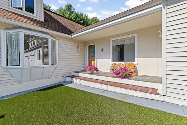 a view of a house with a tub and a yard