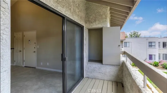 a view of balcony with wooden floor and stairs