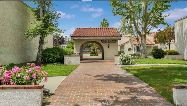 a view of a garden with flowers and trees