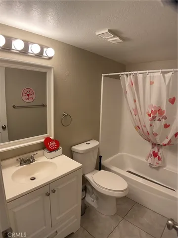 a bathroom with a sink a toilet and a shower