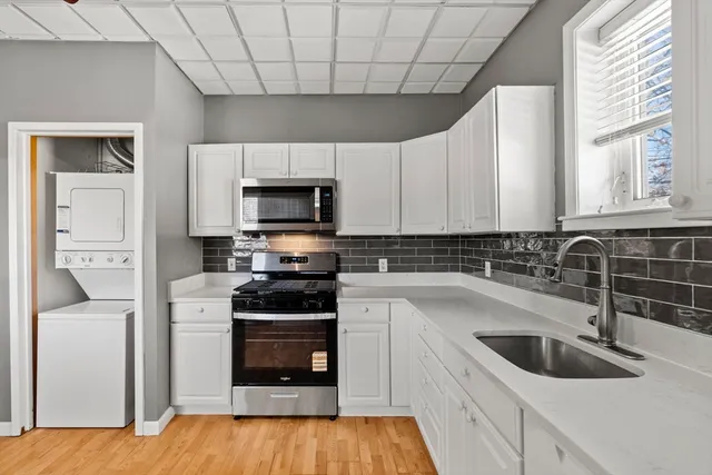 a kitchen with a sink cabinets and stainless steel appliances