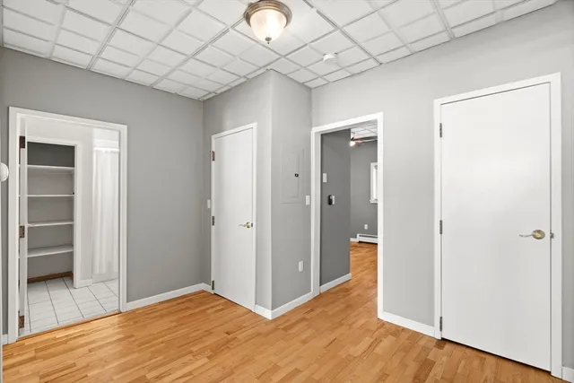 a view of empty room with wooden floor