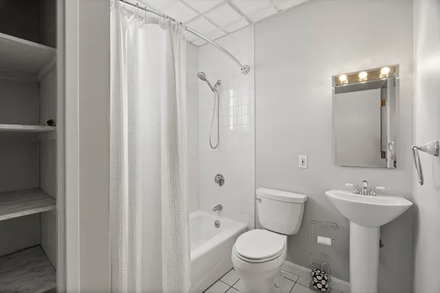 a bathroom with a toilet sink and shower