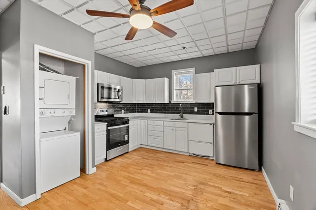 a kitchen with cabinets and stainless steel appliances