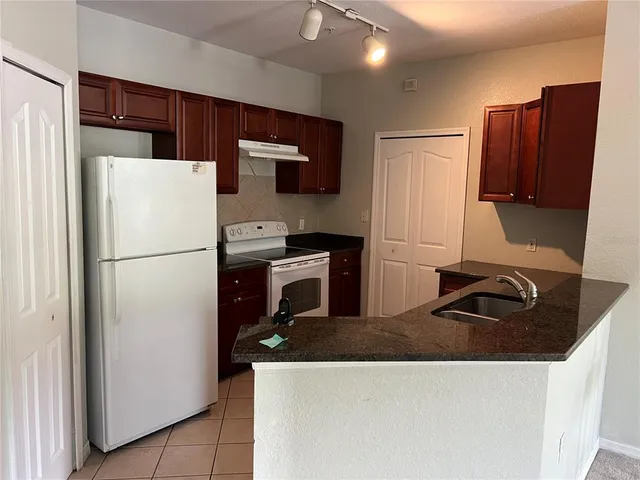 a big room with windows and a chandelier