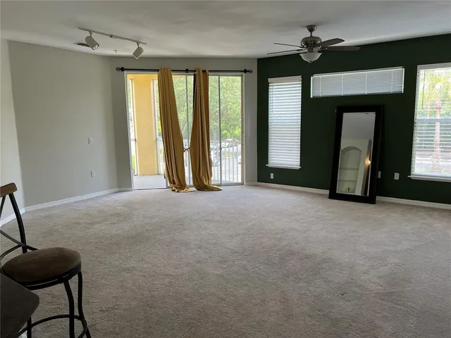 a bathroom with a granite countertop sink toilet and mirror