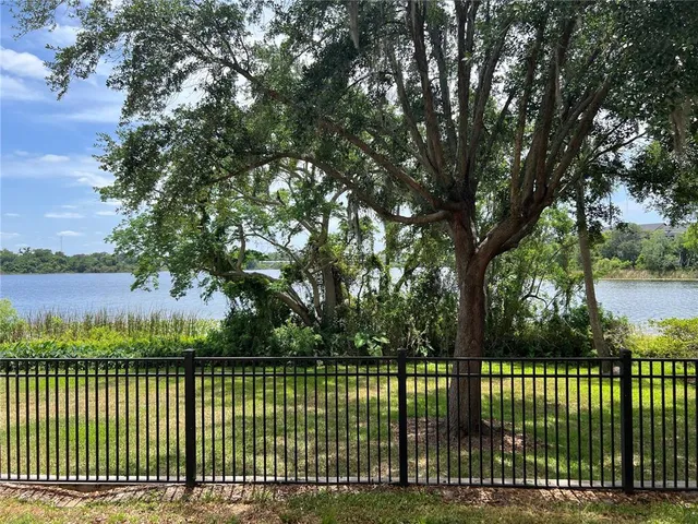a view of a park with iron fence