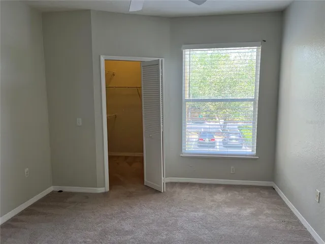 an empty room with windows and closet