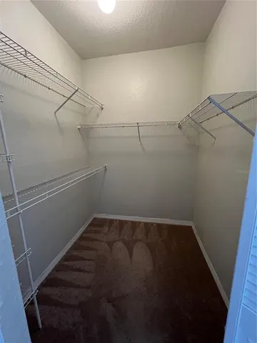 a kitchen with stainless steel appliances a refrigerator a sink a stove top oven a counter space and cabinets