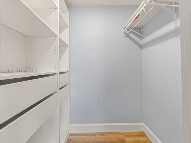 a view of walk in closet with empty racks