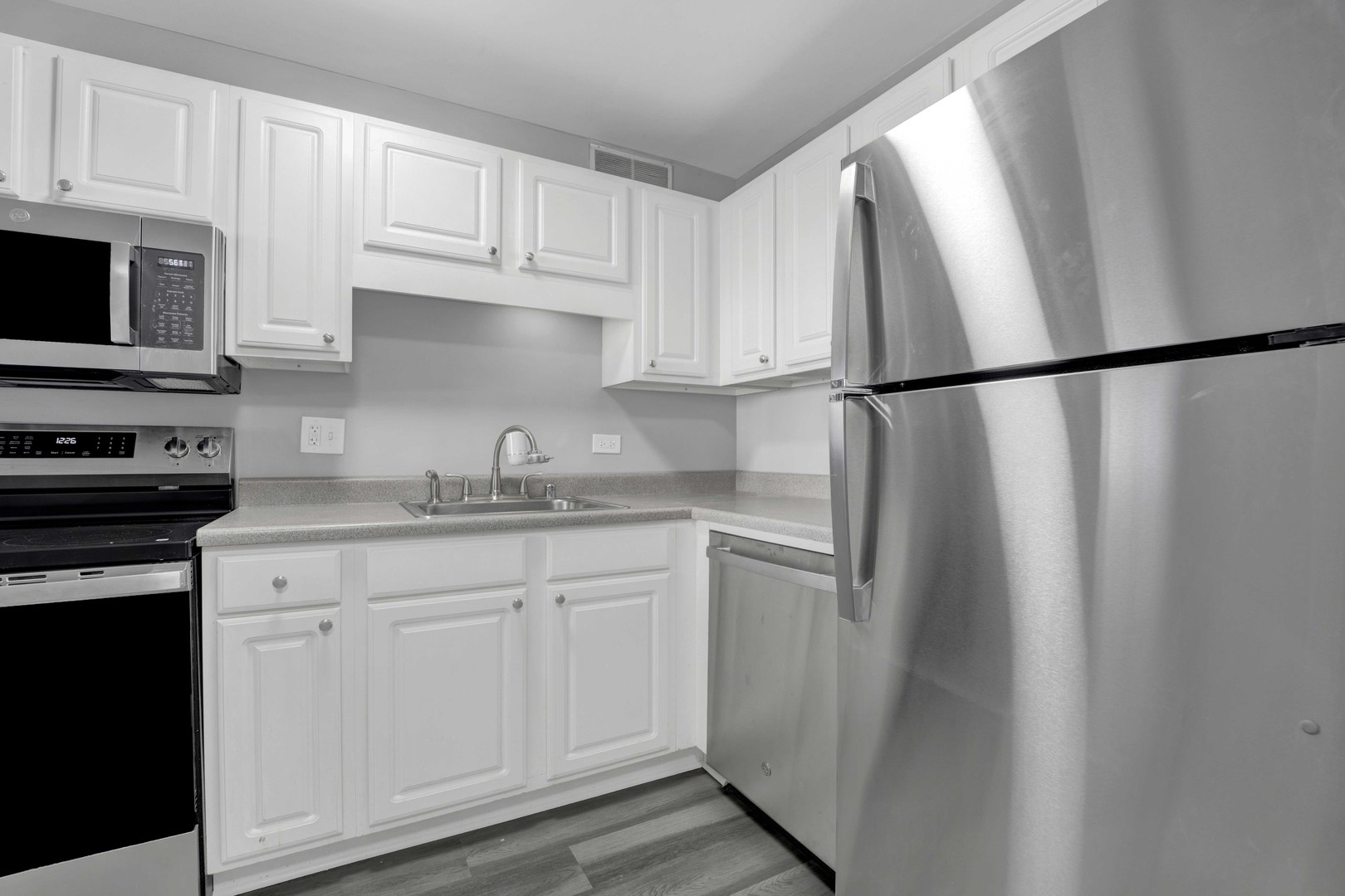 211 East Ohio Street, Unit 2925 Chicago, IL 60611 - Photo 4 of 14 a kitchen with stainless steel appliances granite countertop a refrigerator a sink and white cabinets