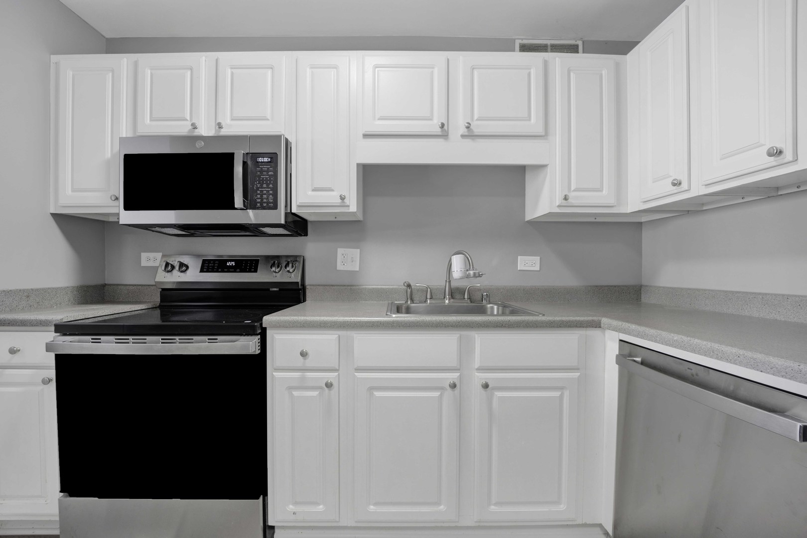 211 East Ohio Street, Unit 2925 Chicago, IL 60611 - Photo 5 of 14 a kitchen with white cabinets and a stove