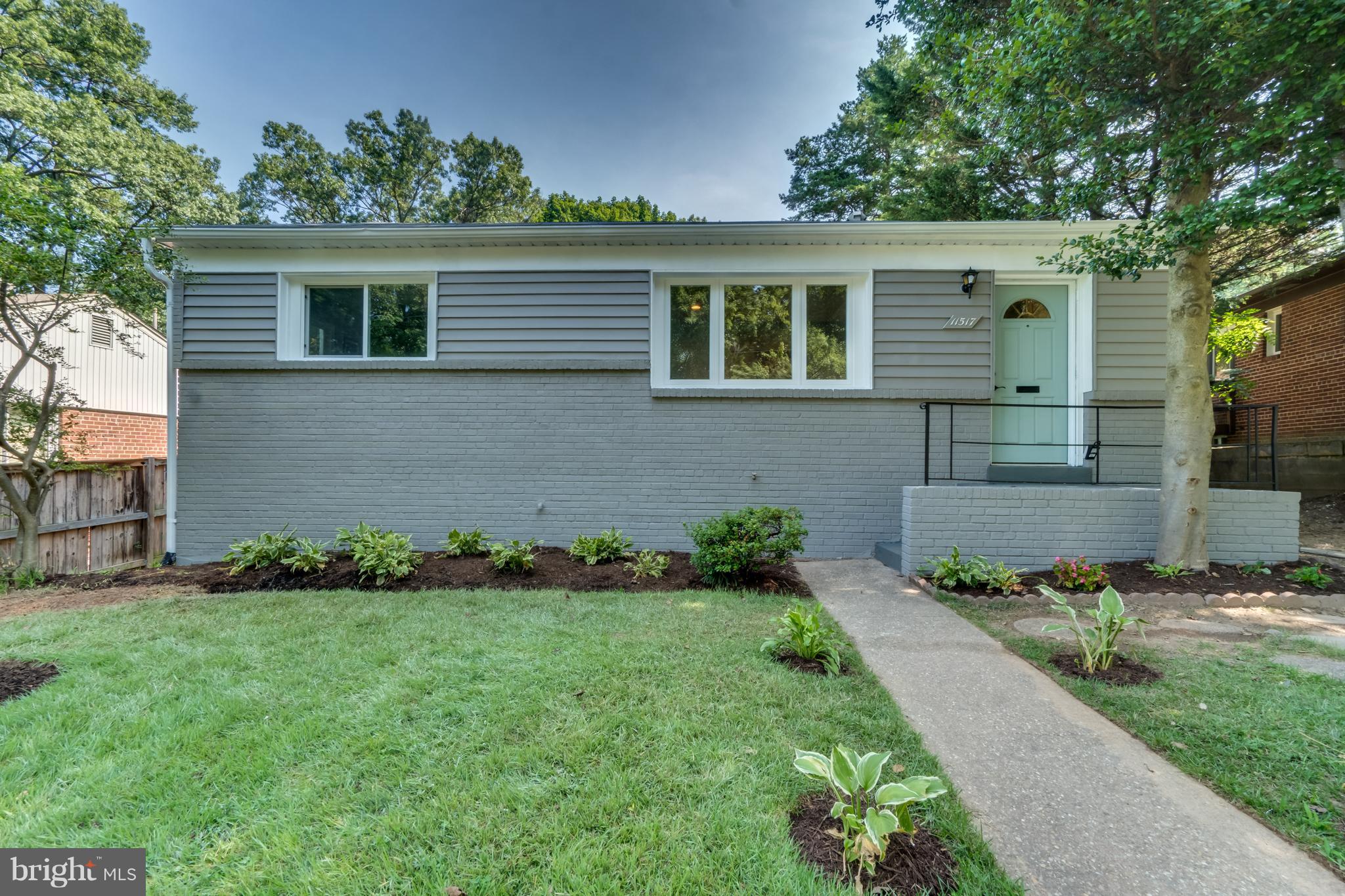 11517 Mapleview Drive Silver Spring, MD 20902 - Photo 1 of 18 a front view of a house with a garden