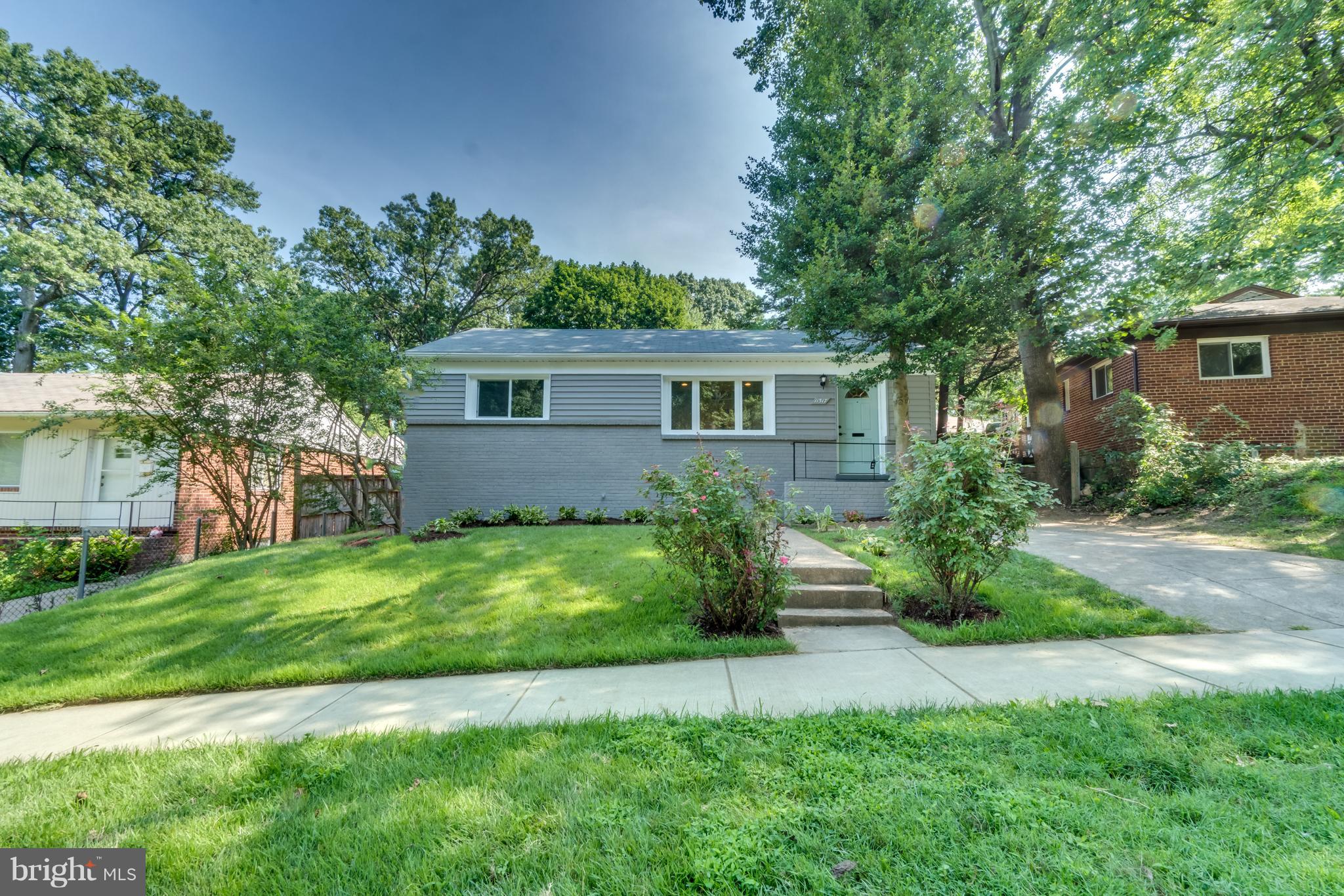 11517 Mapleview Drive Silver Spring, MD 20902 - Photo 2 of 18 a front view of house with yard and green space