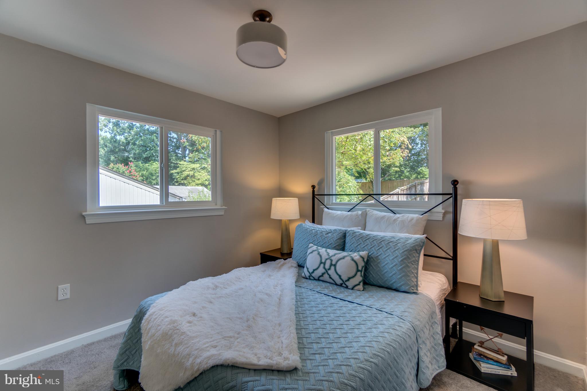 11517 Mapleview Drive Silver Spring, MD 20902 - Photo 11 of 18 a bedroom with furniture and a large window