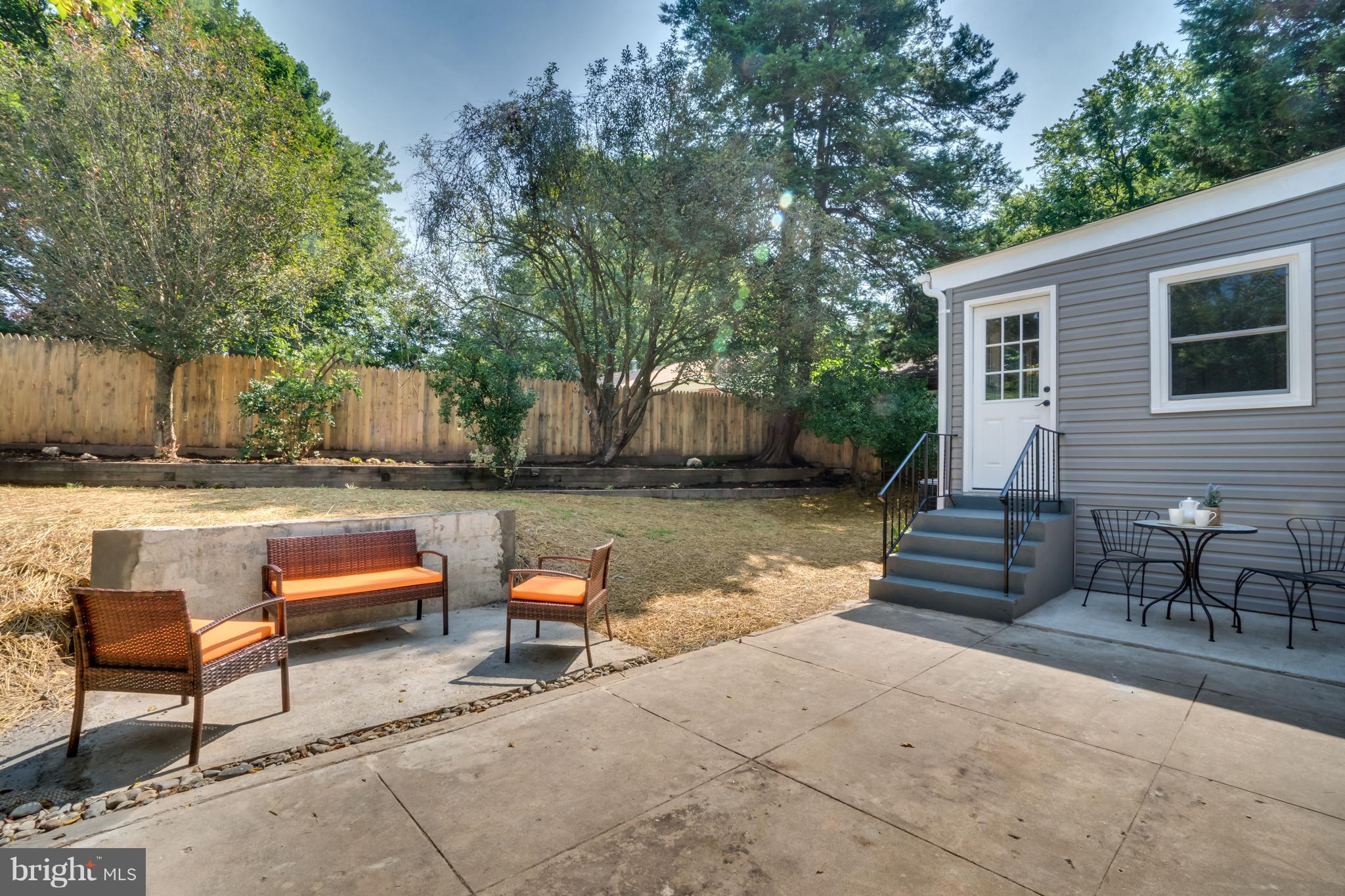 11517 Mapleview Drive Silver Spring, MD 20902 - Photo 18 of 18 a backyard of a house with fire pit and outdoor seating
