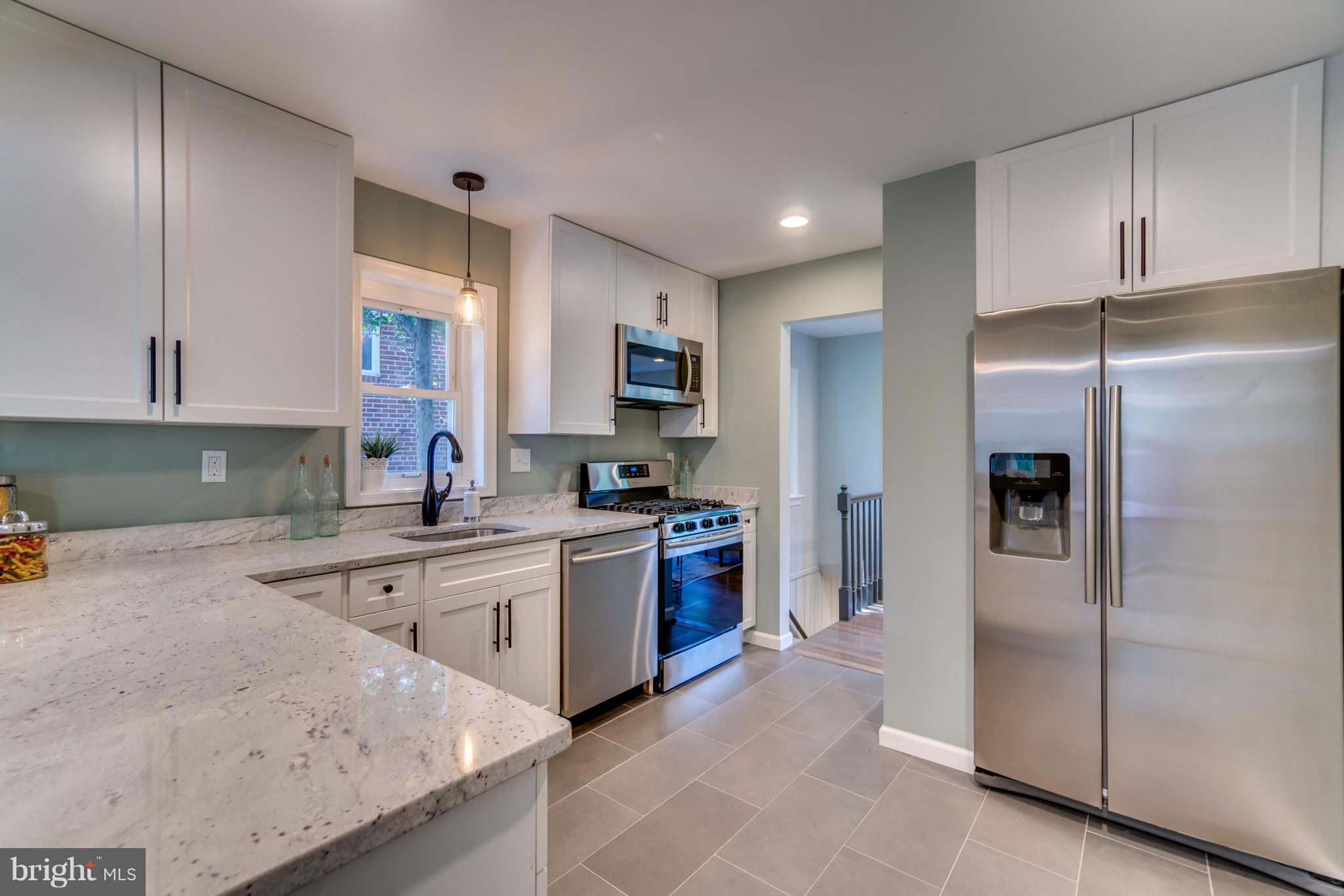 11517 Mapleview Drive Silver Spring, MD 20902 - Photo 7 of 18 a kitchen with a refrigerator and a sink