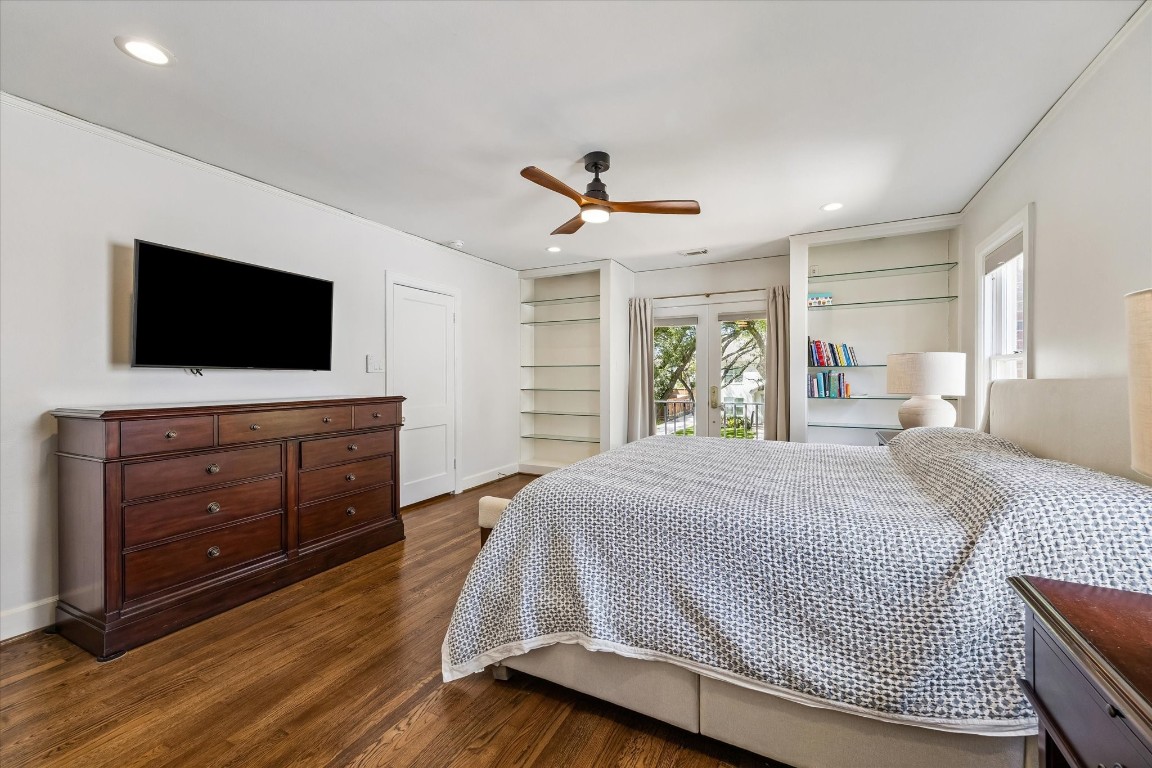 1925 Banks Street Houston, TX 77098 - Photo 18 of 38 Another view of the primary including built-in shelves with french doors opening to a balcony facing the front driveway and street.