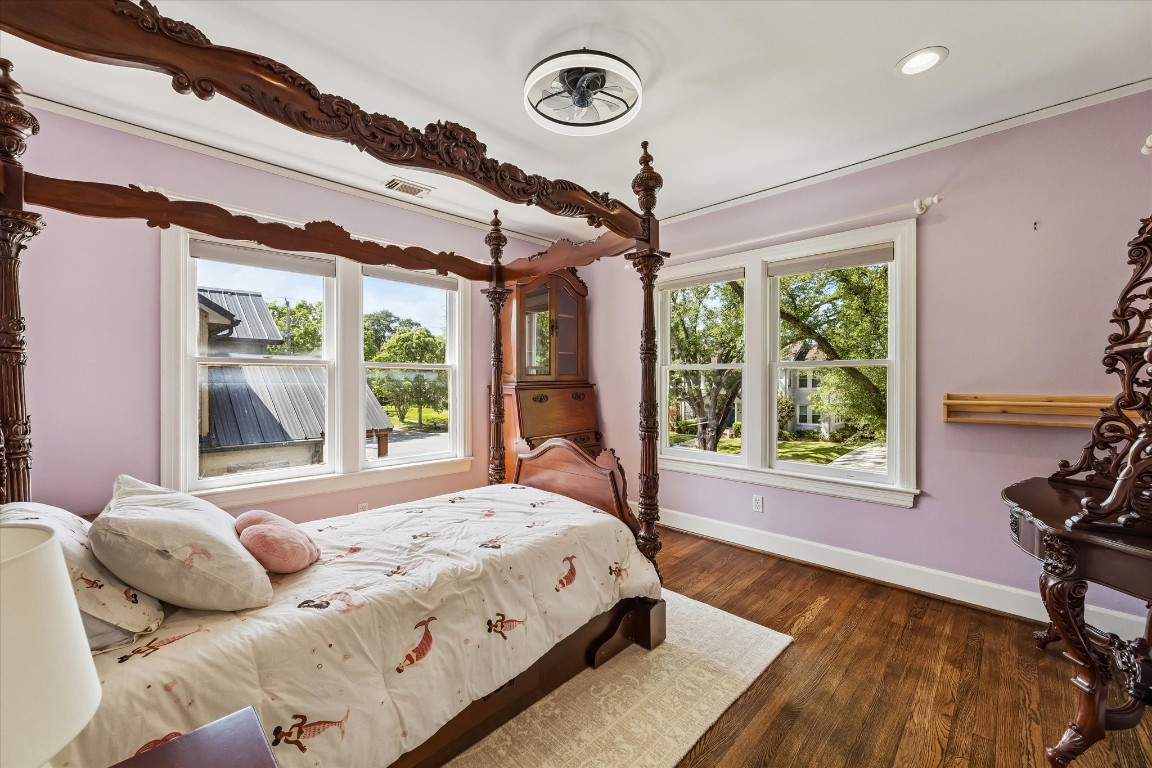 1925 Banks Street Houston, TX 77098 - Photo 27 of 38 The third bedroom in the home with ample natural light and views of a lush, green landscape and tree lined street. The walls are painted in a soft lavender.