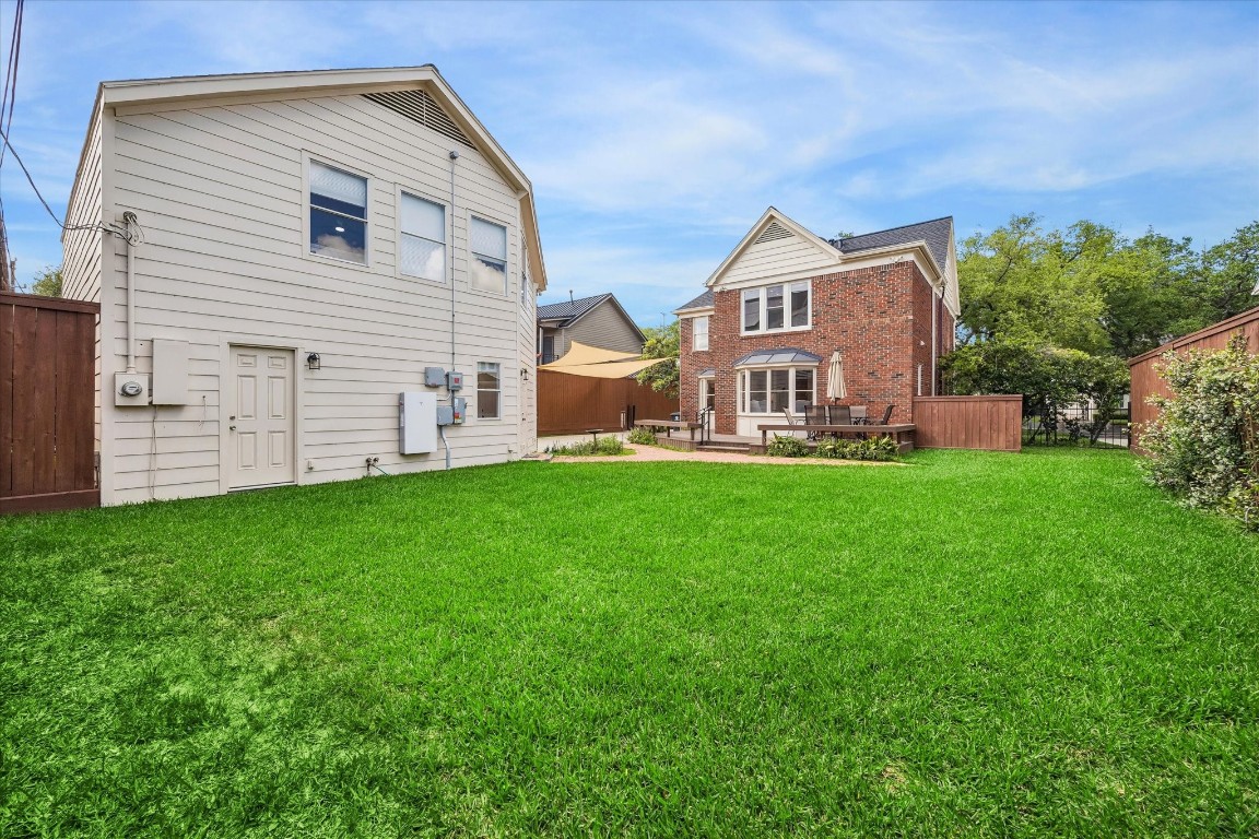 1925 Banks Street Houston, TX 77098 - Photo 36 of 38 A spacious backyard with a well-maintained lawn with a patio area perfect for outdoor dining and relaxation.