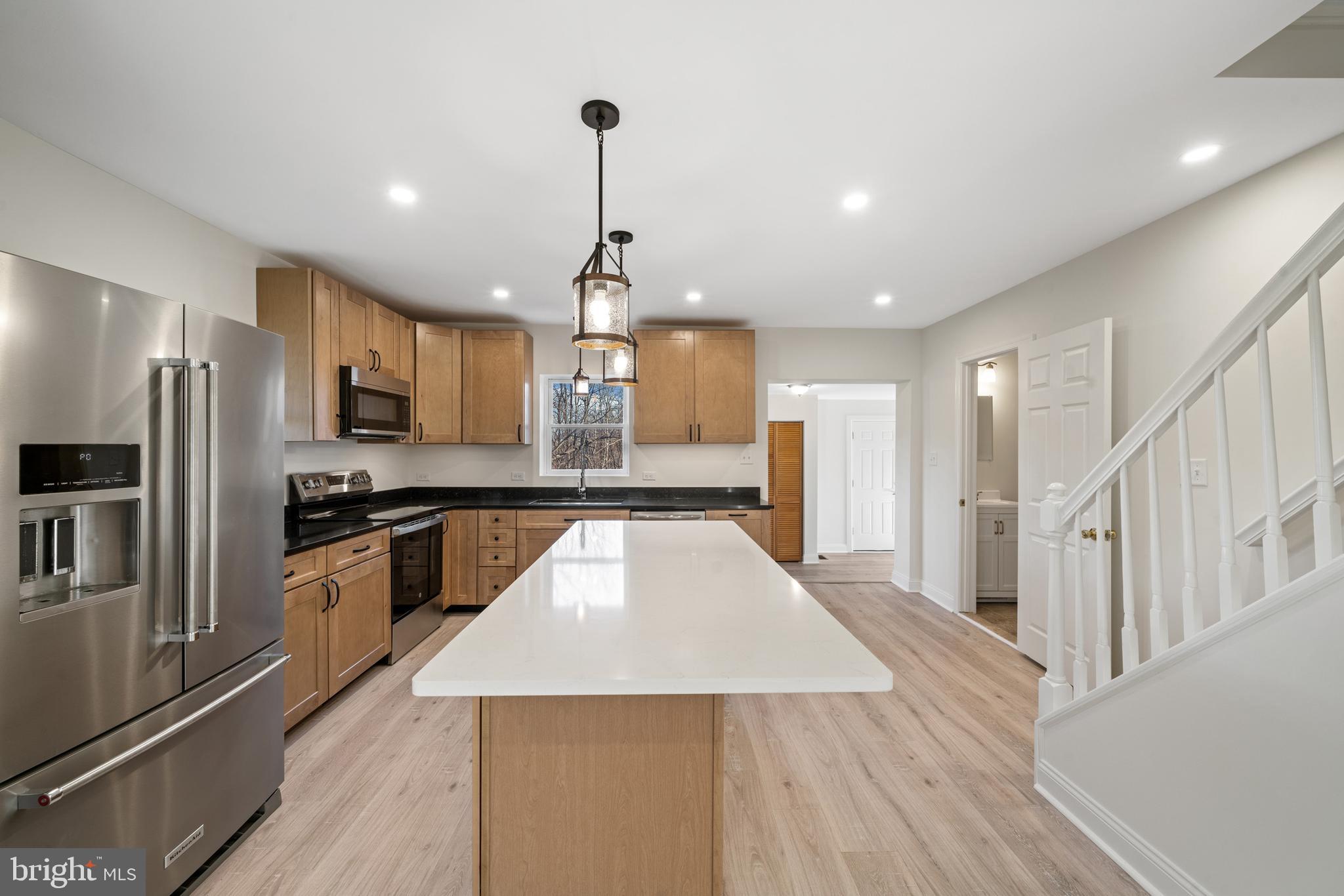 5209 Woodville Road Mount Airy, MD 21771 - Photo 12 of 90 a large kitchen with a large counter top appliances and cabinets