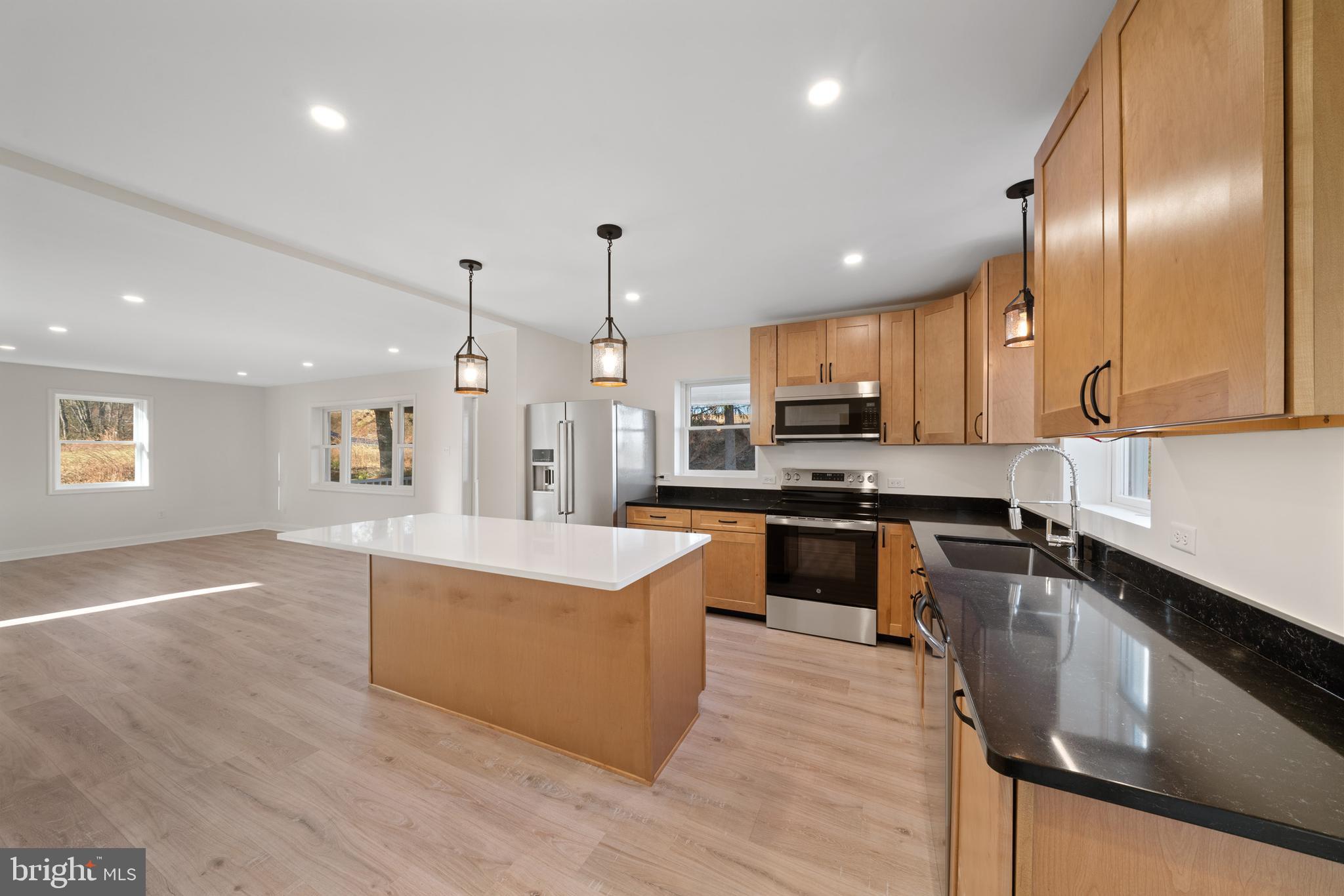 5209 Woodville Road Mount Airy, MD 21771 - Photo 14 of 90 a large kitchen with granite countertop a large counter top stainless steel appliances and cabinets
