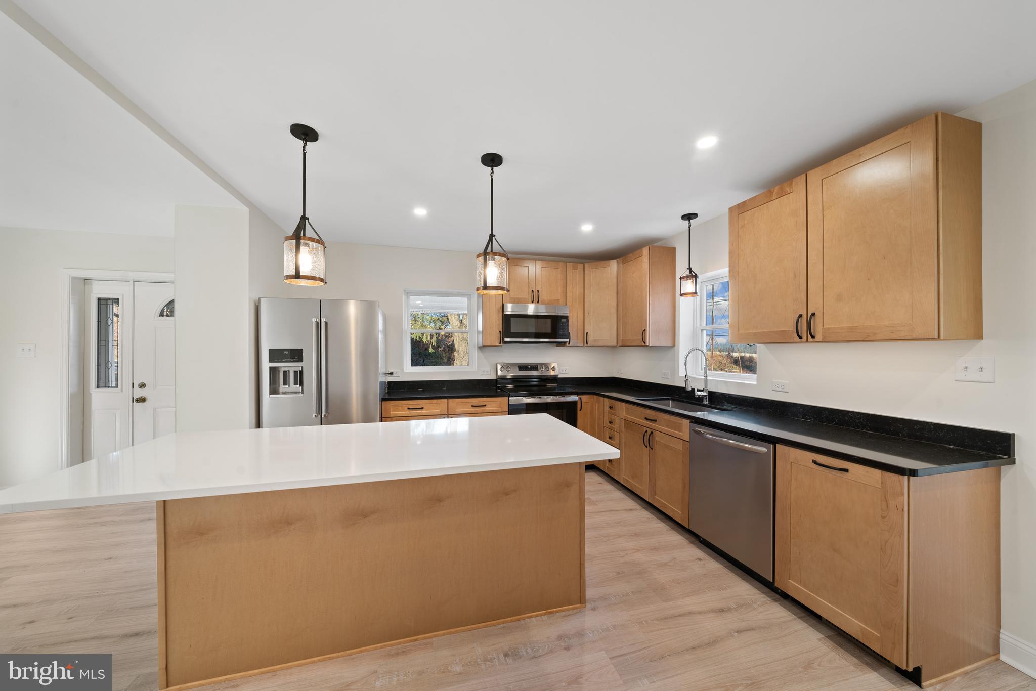 5209 Woodville Road Mount Airy, MD 21771 - Photo 15 of 90 a large kitchen with stainless steel appliances kitchen island granite countertop a sink a stove and a refrigerator