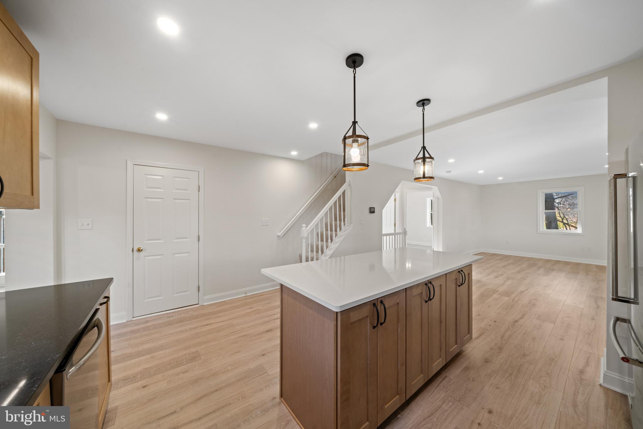5209 Woodville Road Mount Airy, MD 21771 - Photo 16 of 90 a kitchen with a sink chandelier and wooden floor