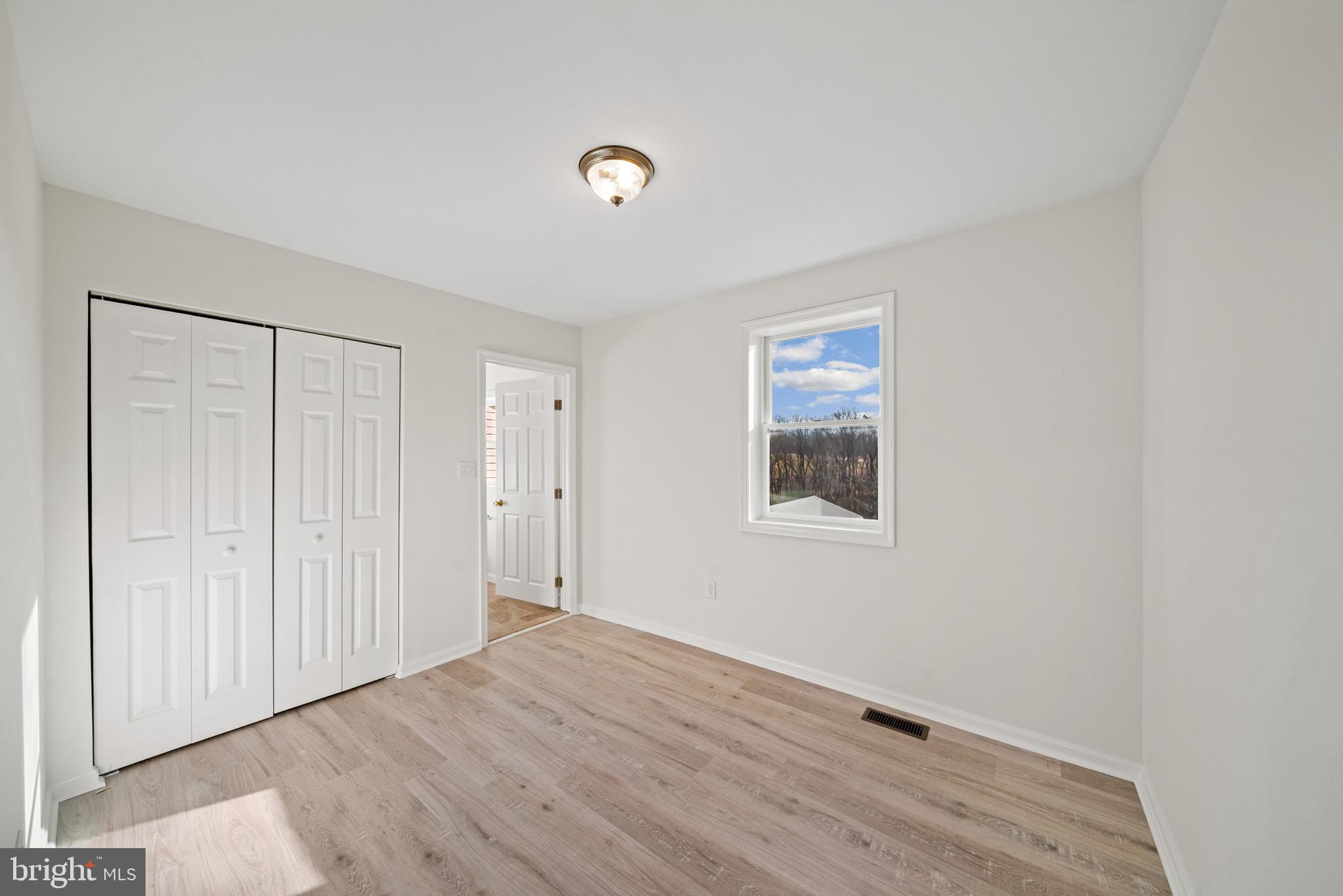 5209 Woodville Road Mount Airy, MD 21771 - Photo 23 of 90 a view of an empty room with wooden floor