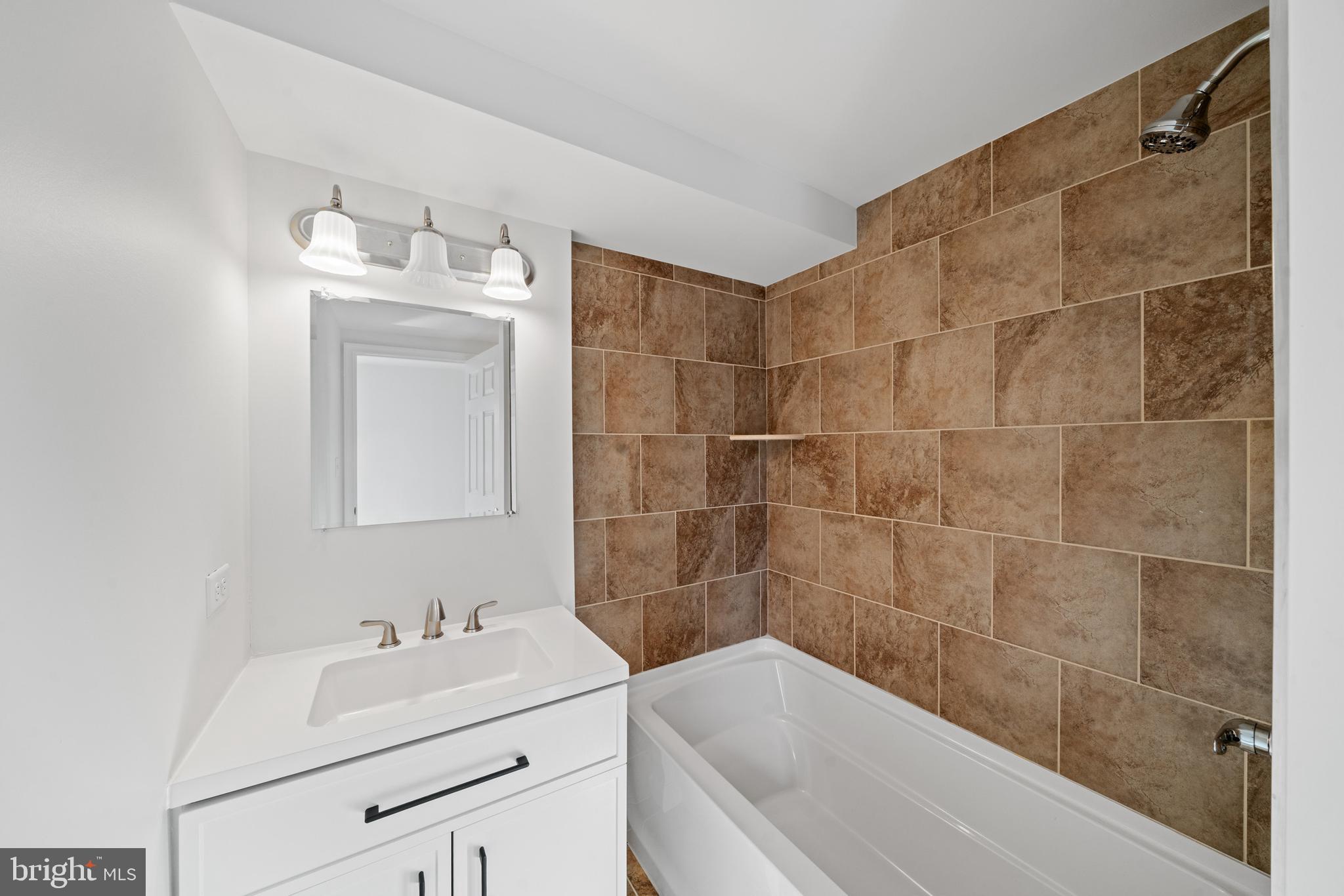 5209 Woodville Road Mount Airy, MD 21771 - Photo 33 of 90 a bathroom with a sink mirror toilet and bathtub