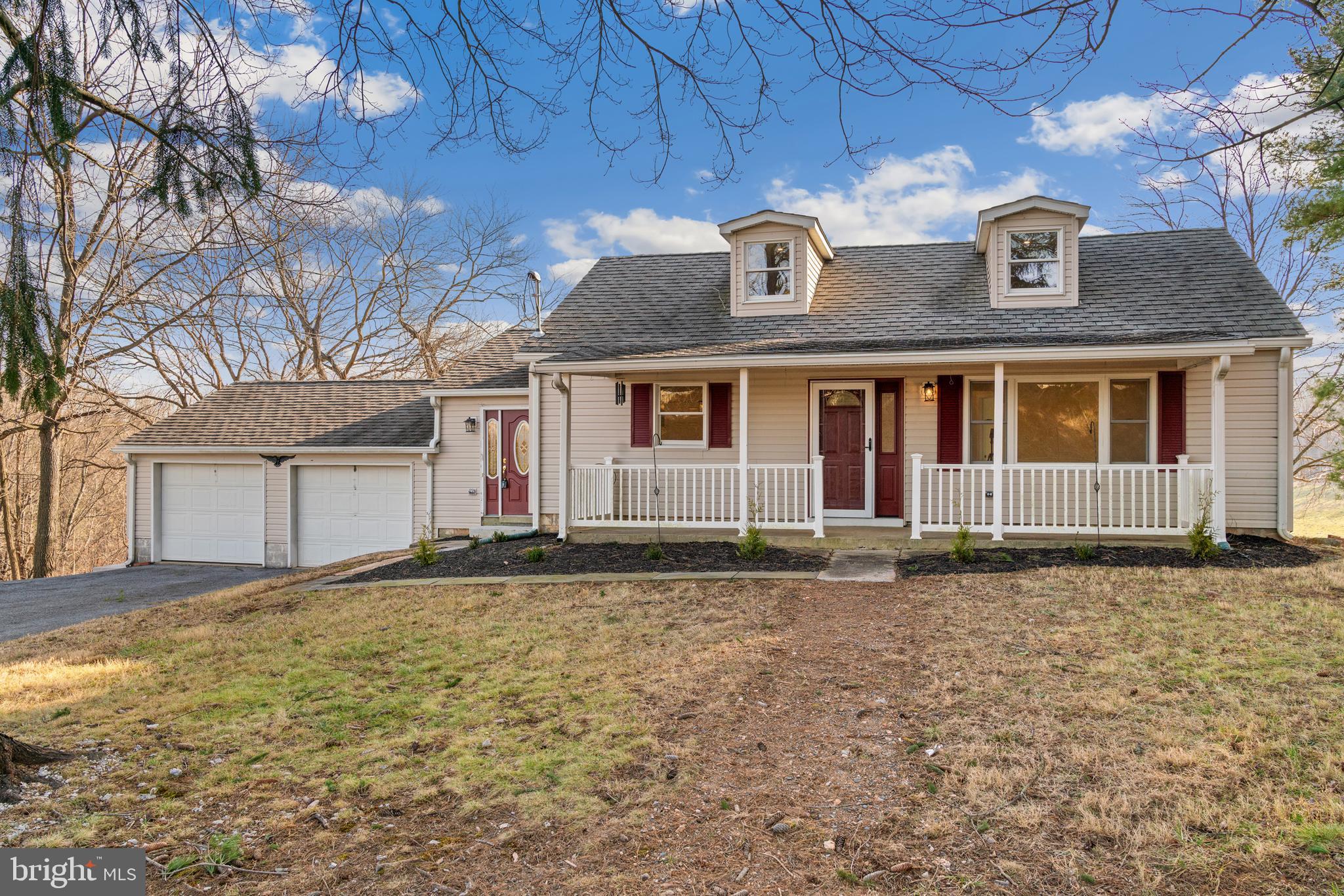 5209 Woodville Road Mount Airy, MD 21771 - Photo 4 of 90 a front view of a house with a garden