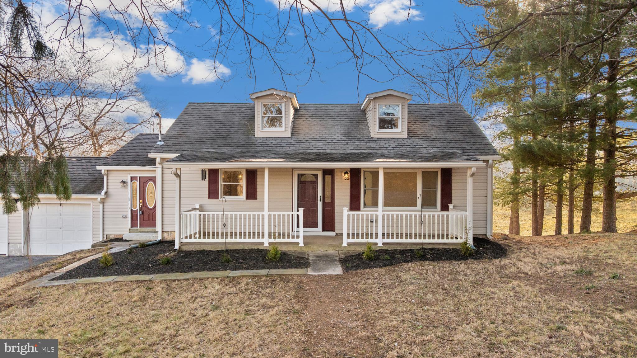 5209 Woodville Road Mount Airy, MD 21771 - Photo 5 of 90 a front view of a house with a yard