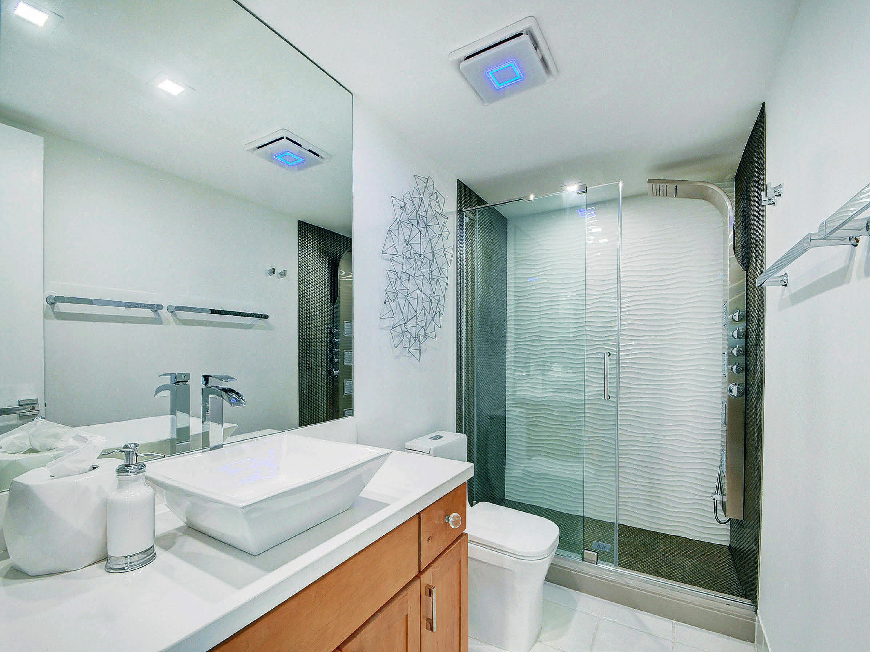 3460 South Ocean Boulevard, Unit 7110 Palm Beach, FL 33480 - Photo 15 of 23 a bathroom with a sink a toilet a mirror and shower