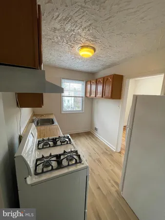 a kitchen with a stove a sink and a refrigerator