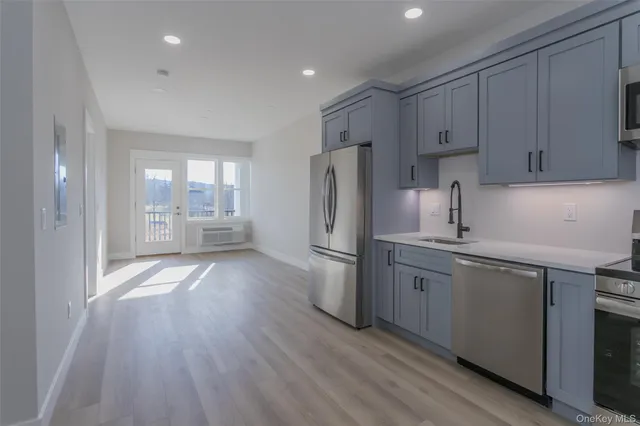 a kitchen with refrigerator and cabinets