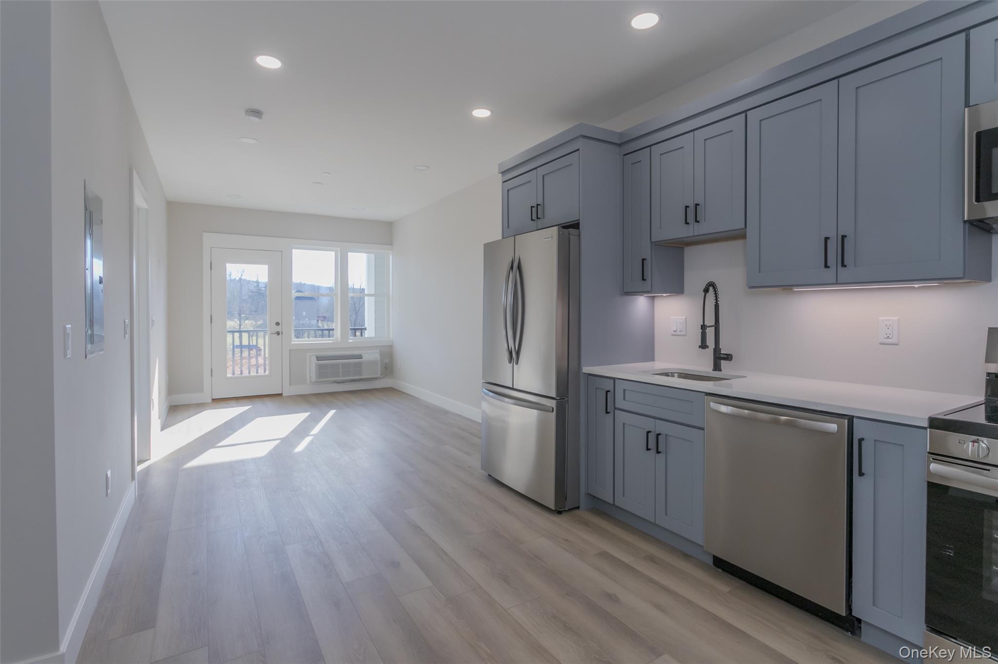 124 South Main Street, Unit 2203 Florida, NY 10921 - Photo 5 of 16 a kitchen with refrigerator and cabinets