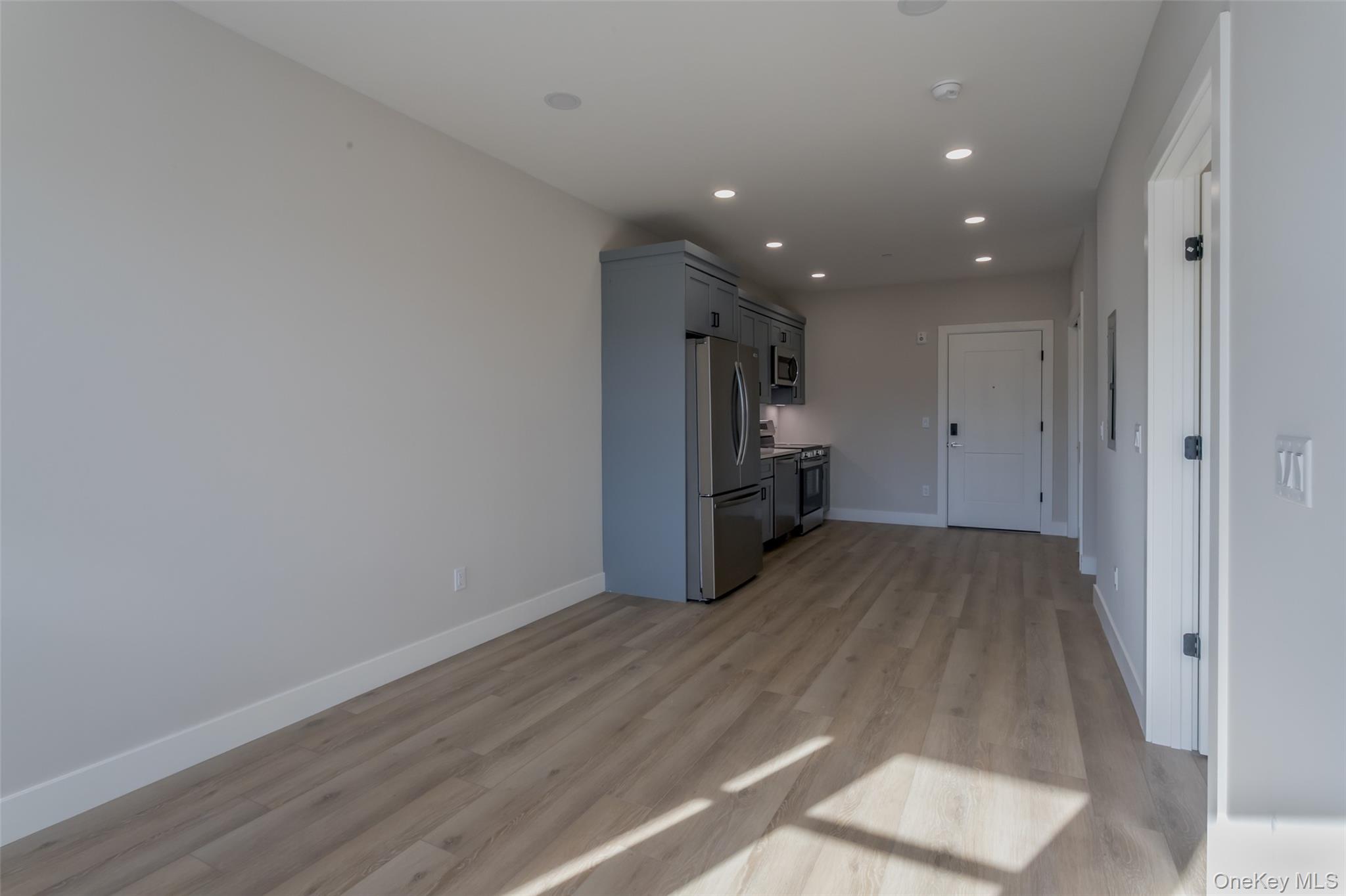 124 South Main Street, Unit 2203 Florida, NY 10921 - Photo 7 of 16 a view of empty room with wooden floor