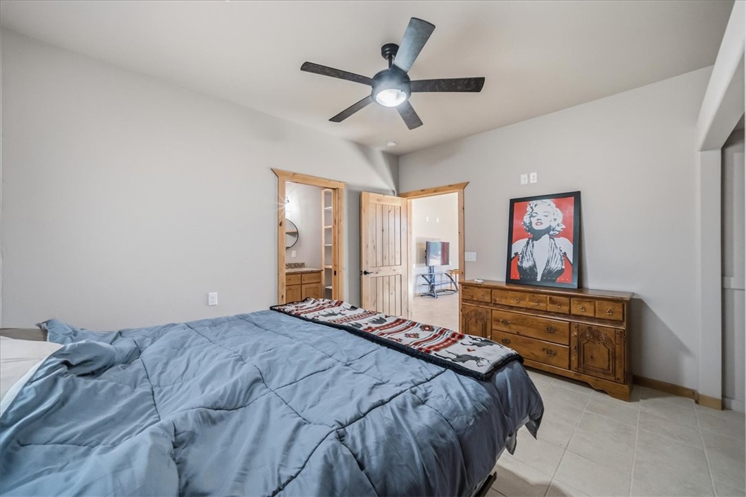 10374 East Happy Trails Road Kingman, AZ 86401 - Photo 28 of 68 a bedroom with a bed and a chandelier
