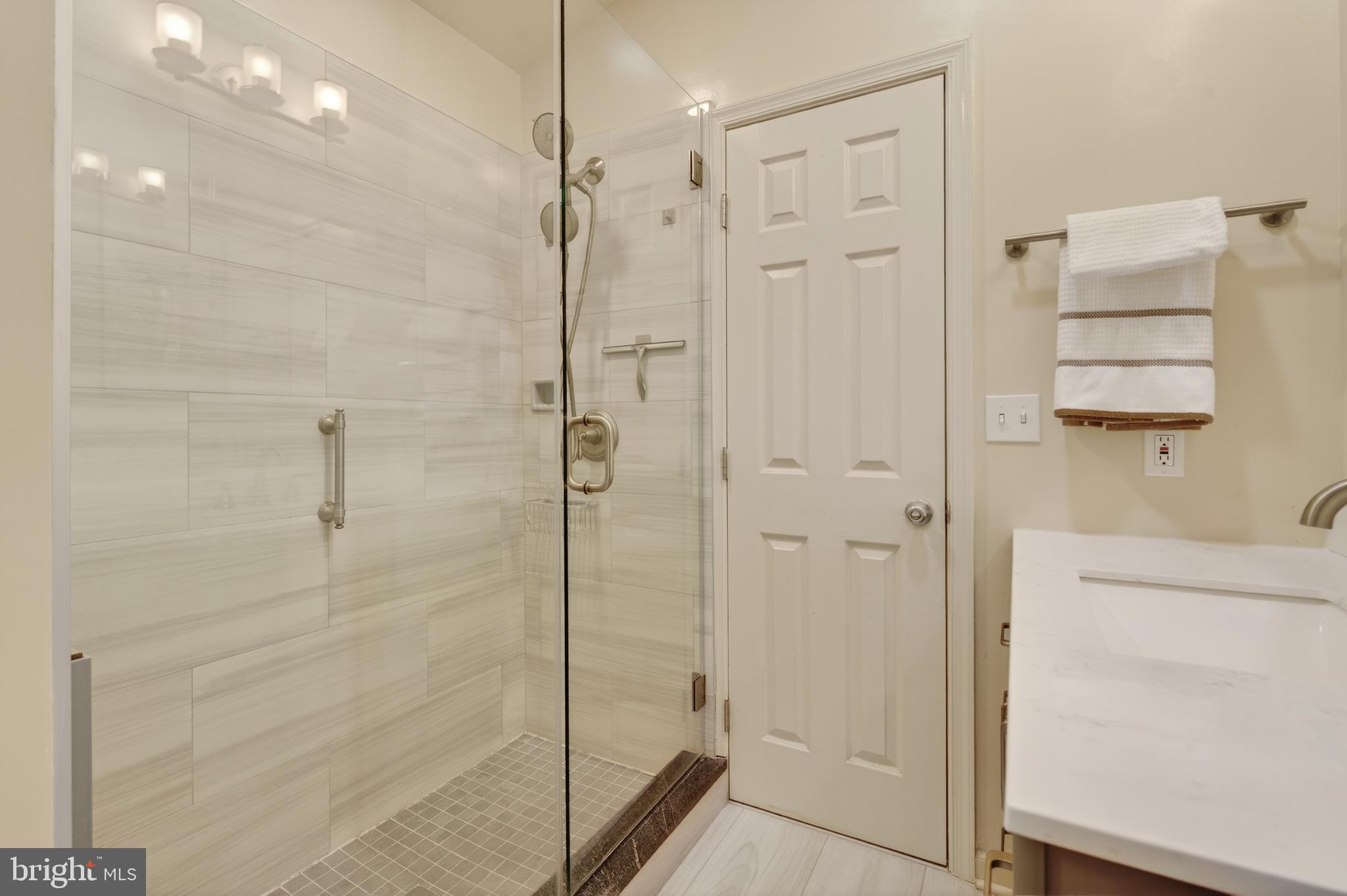8901 Ellsworth Court Silver Spring, MD 20910 - Photo 32 of 43 a bathroom with a shower and a glass door