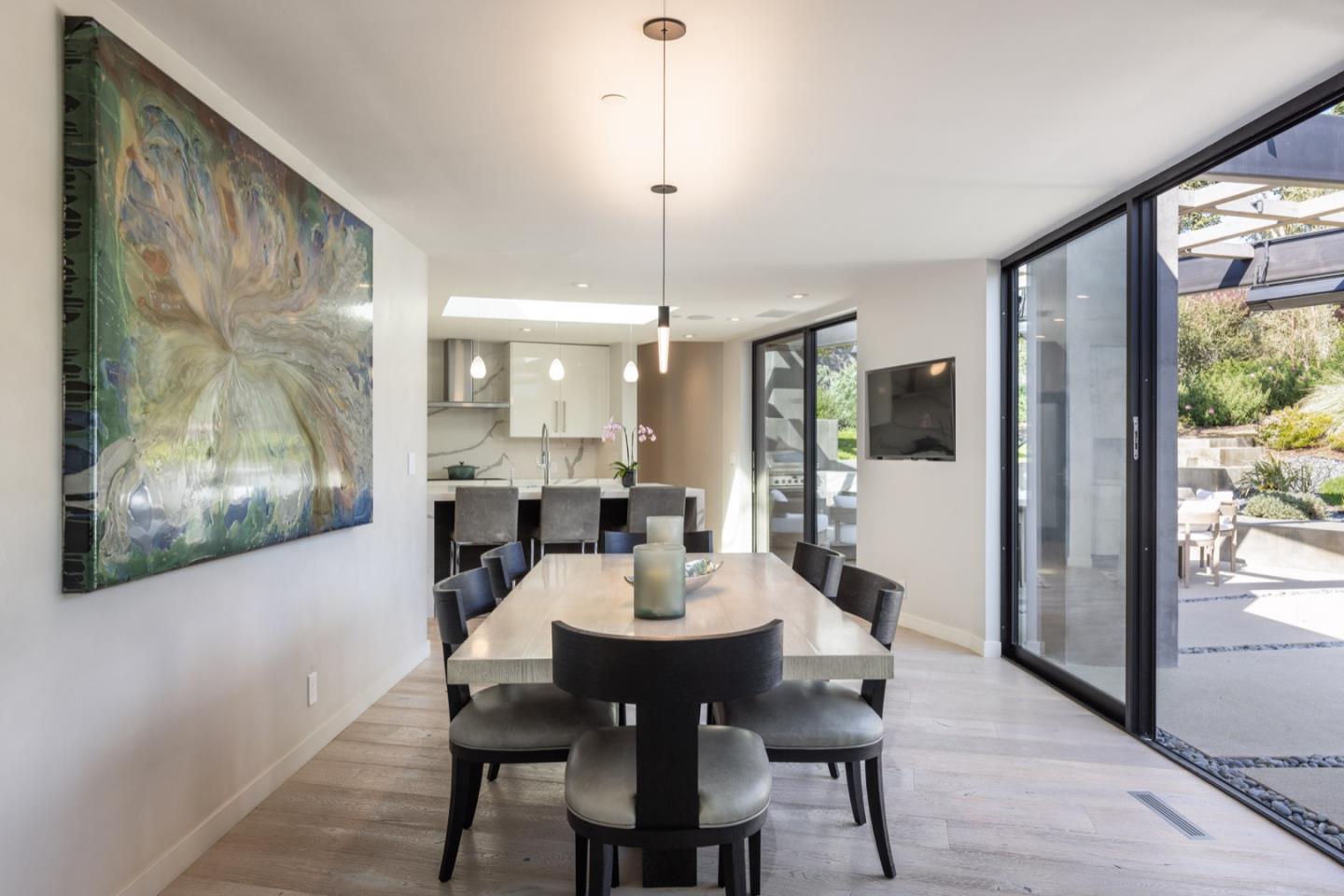 1505 Venadero Road Pebble Beach, CA 93953 - Photo 11 of 34 a view of a dining room with furniture window and wooden floor