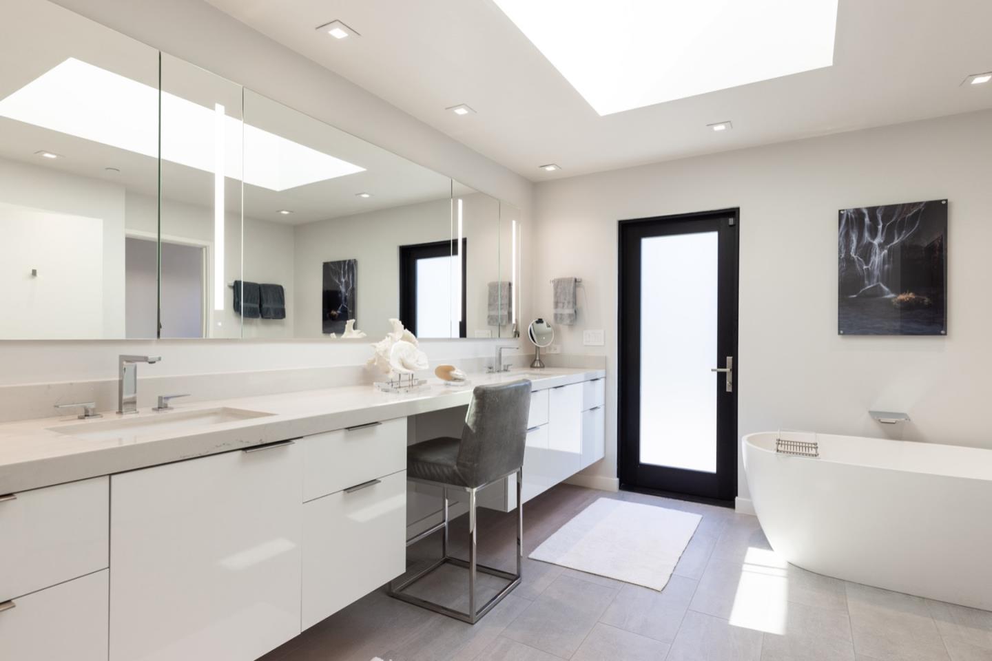 1505 Venadero Road Pebble Beach, CA 93953 - Photo 23 of 34 a spacious bathroom with a double vanity sink a mirror and a bathtub