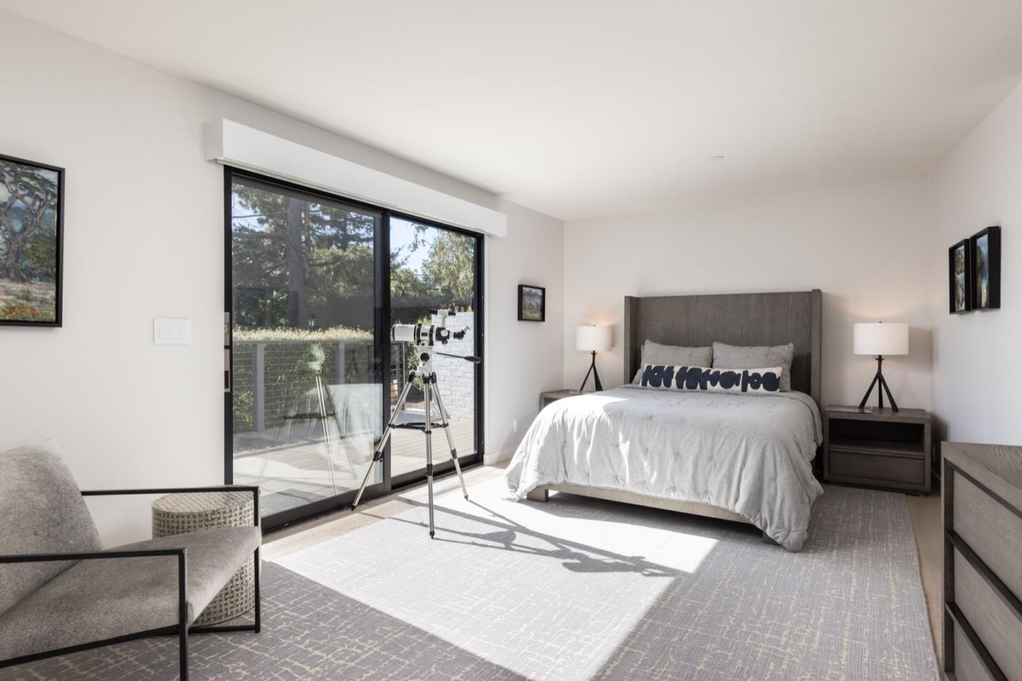 1505 Venadero Road Pebble Beach, CA 93953 - Photo 24 of 34 a bedroom with a bed and wooden floor