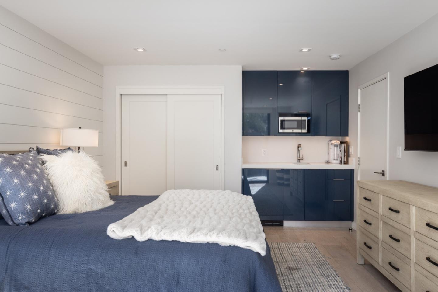 1505 Venadero Road Pebble Beach, CA 93953 - Photo 31 of 34 a spacious bedroom with a bed and a flat screen tv