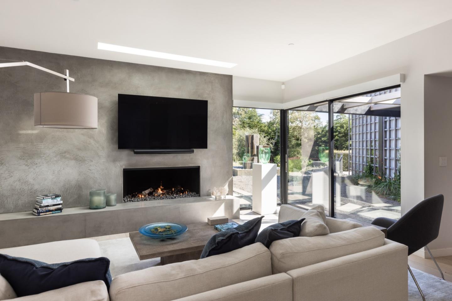 1505 Venadero Road Pebble Beach, CA 93953 - Photo 9 of 34 a living room with furniture a large window and a fireplace